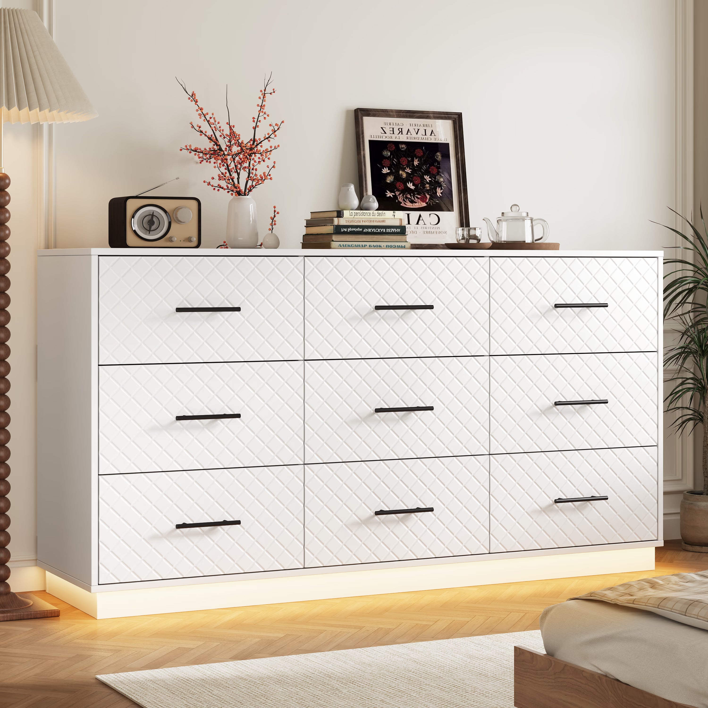 White 9-drawer dresser with warm LED light strip glowing in a bedroom