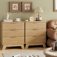 Two Linea natural oak 3-drawer nightstands placed side by side next to a sofa, creating a wide fluted dresser for extended living room storage.