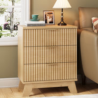 Linea modern natural oak fluted 3-drawer nightstand with gold metal handles, styled with a white lamp and framed art by a window.