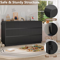 Two fluted black wood dressers styled side by side in a modern kids bedroom setting