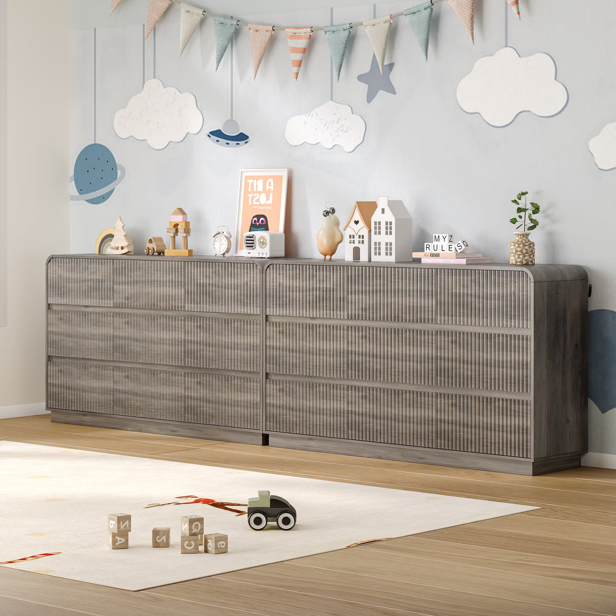 Child playing safely on the floor next to a sturdy fluted gray wood kids dresser