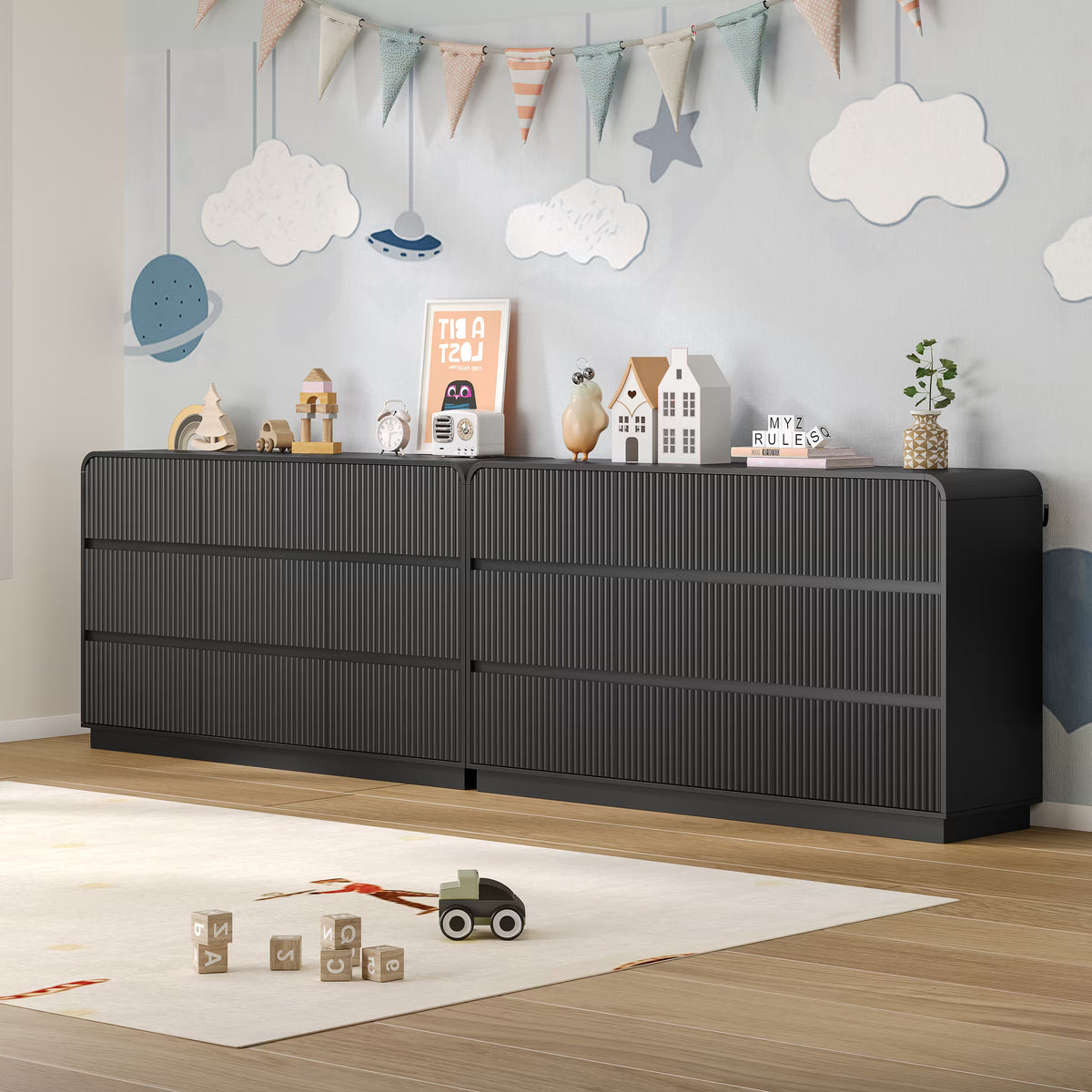 Child playing safely on the floor next to a sturdy fluted black wood kids dresser