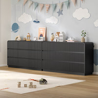 Child playing safely on the floor next to a sturdy fluted black wood kids dresser