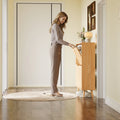 Elora natural oak finish slim shoe cabinet shown from the side in a narrow entryway