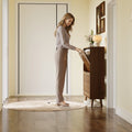 Elora walnut finish slim shoe cabinet shown from the side in a narrow entryway