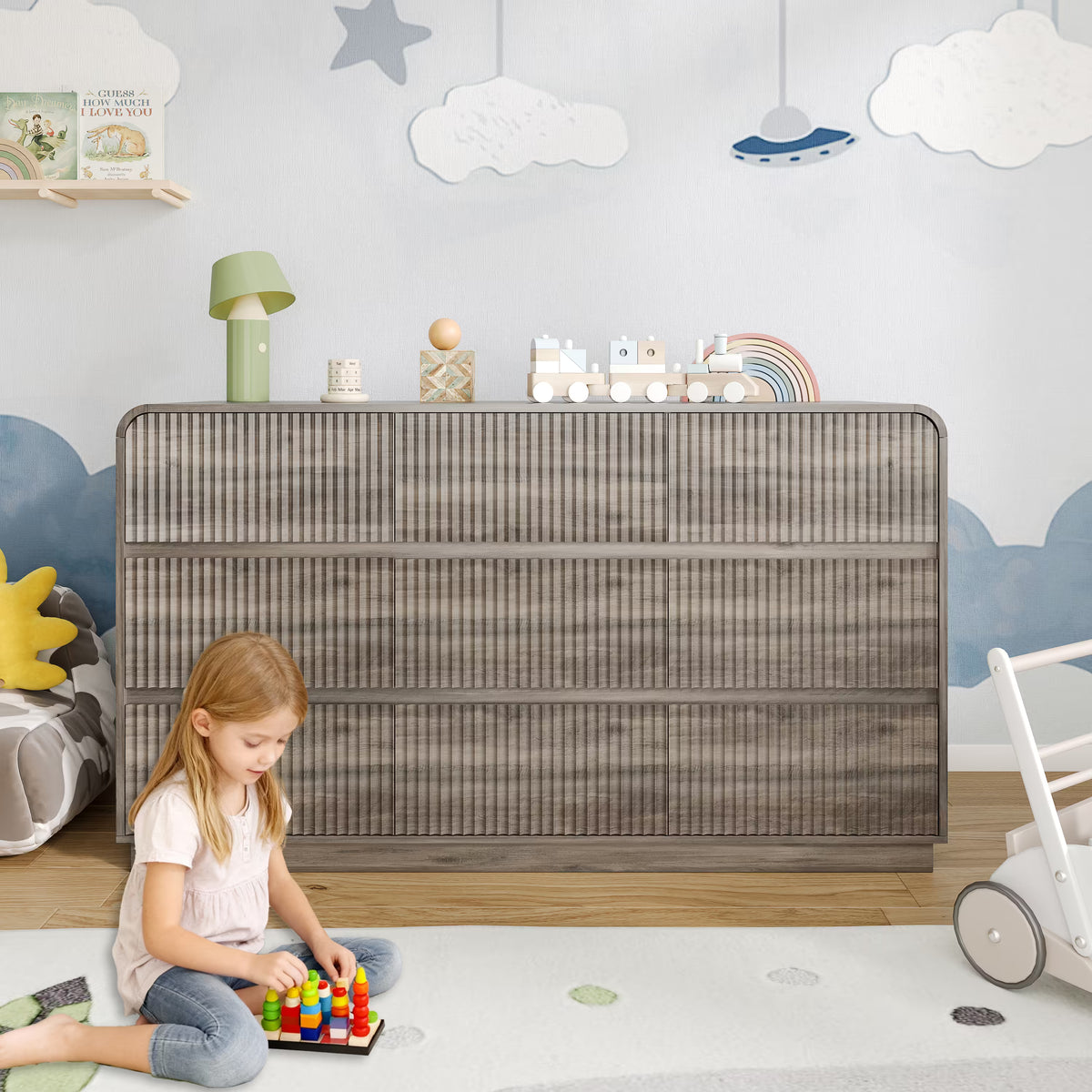 Premium 9 drawer fluted gray wood dresser decorated with charming nursery accessories