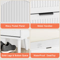 Elora white shoe cabinet details: fluted doors, metal handles and raised legs
