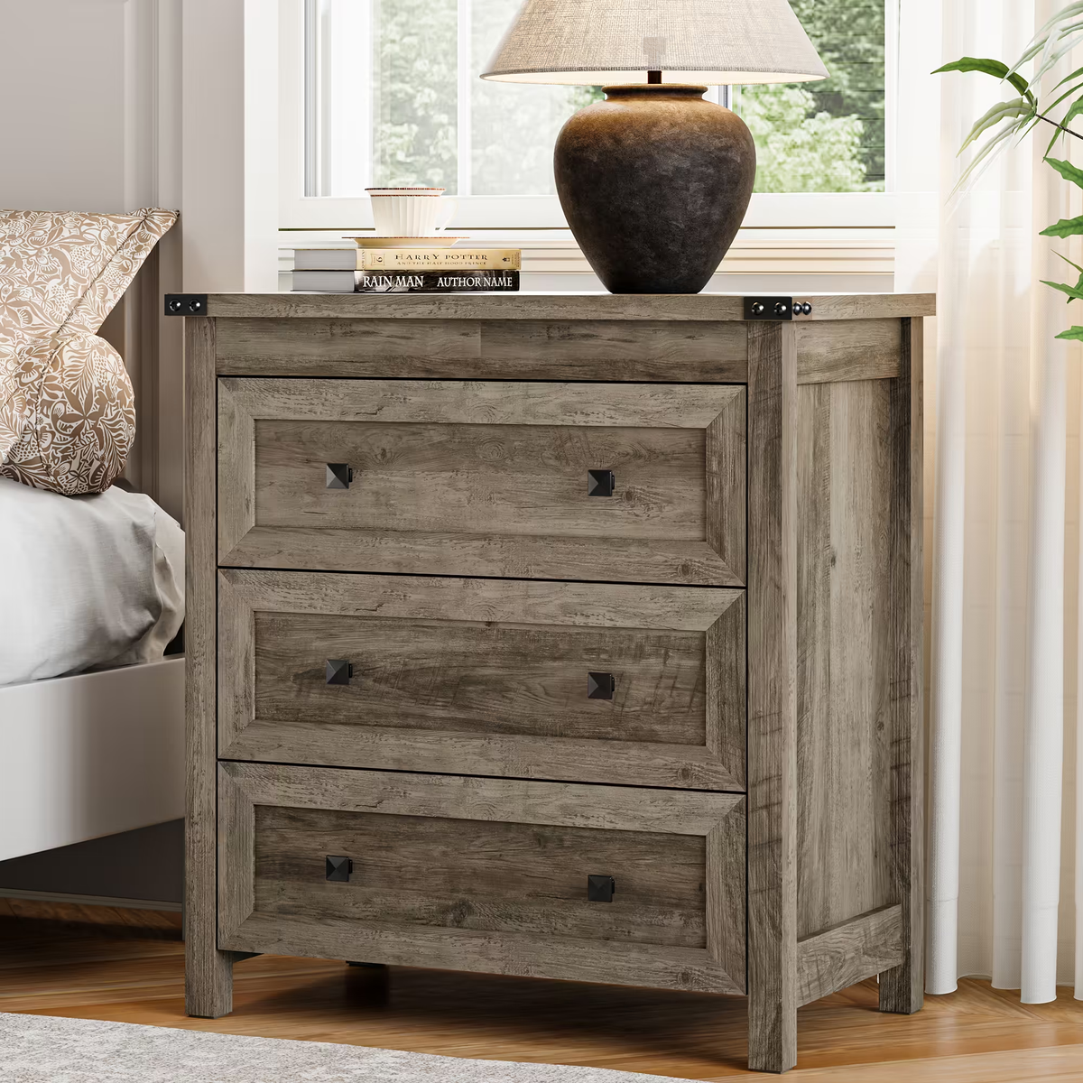 Wood gray farmhouse nightstand with 3 drawers styled beside bed with lamp
