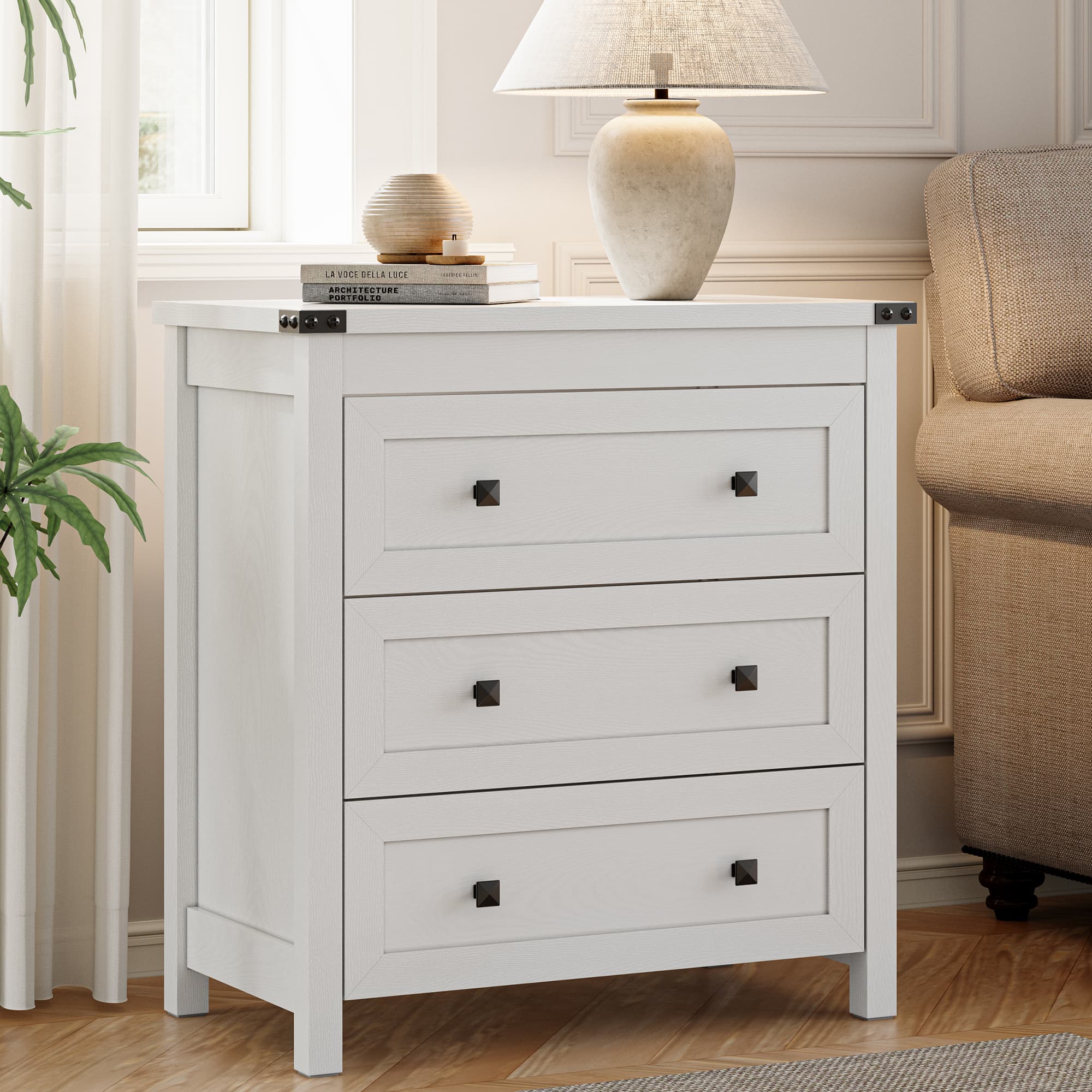 Modern farmhouse end table with 3 storage drawers placed next to sofa in living room with ceramic lamp