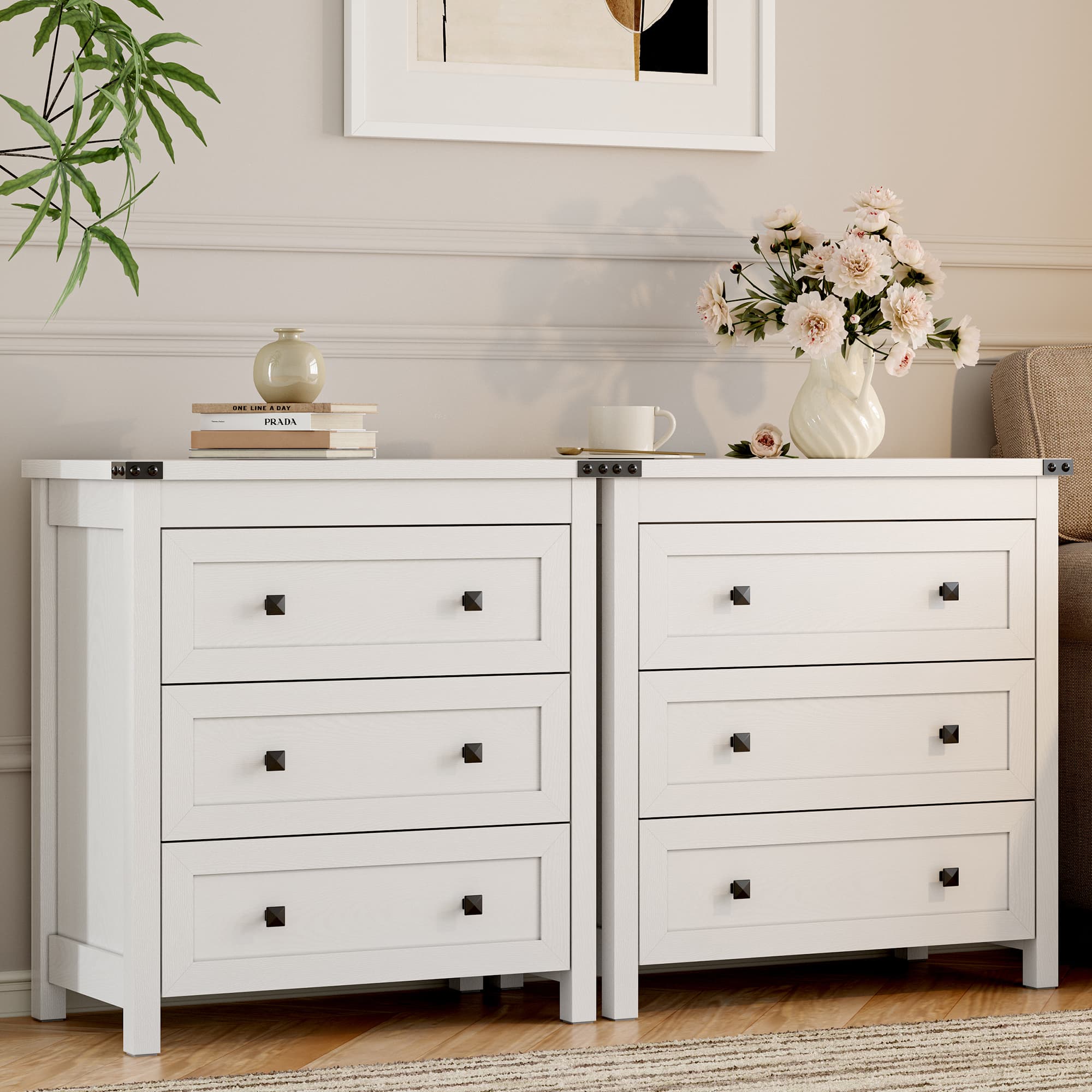 Two white farmhouse nightstands with 3 drawers side by side in living room styled with flowers and books