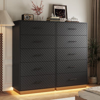Set of two black tall 5-drawer dressers with warm LED base light in a bedroom
