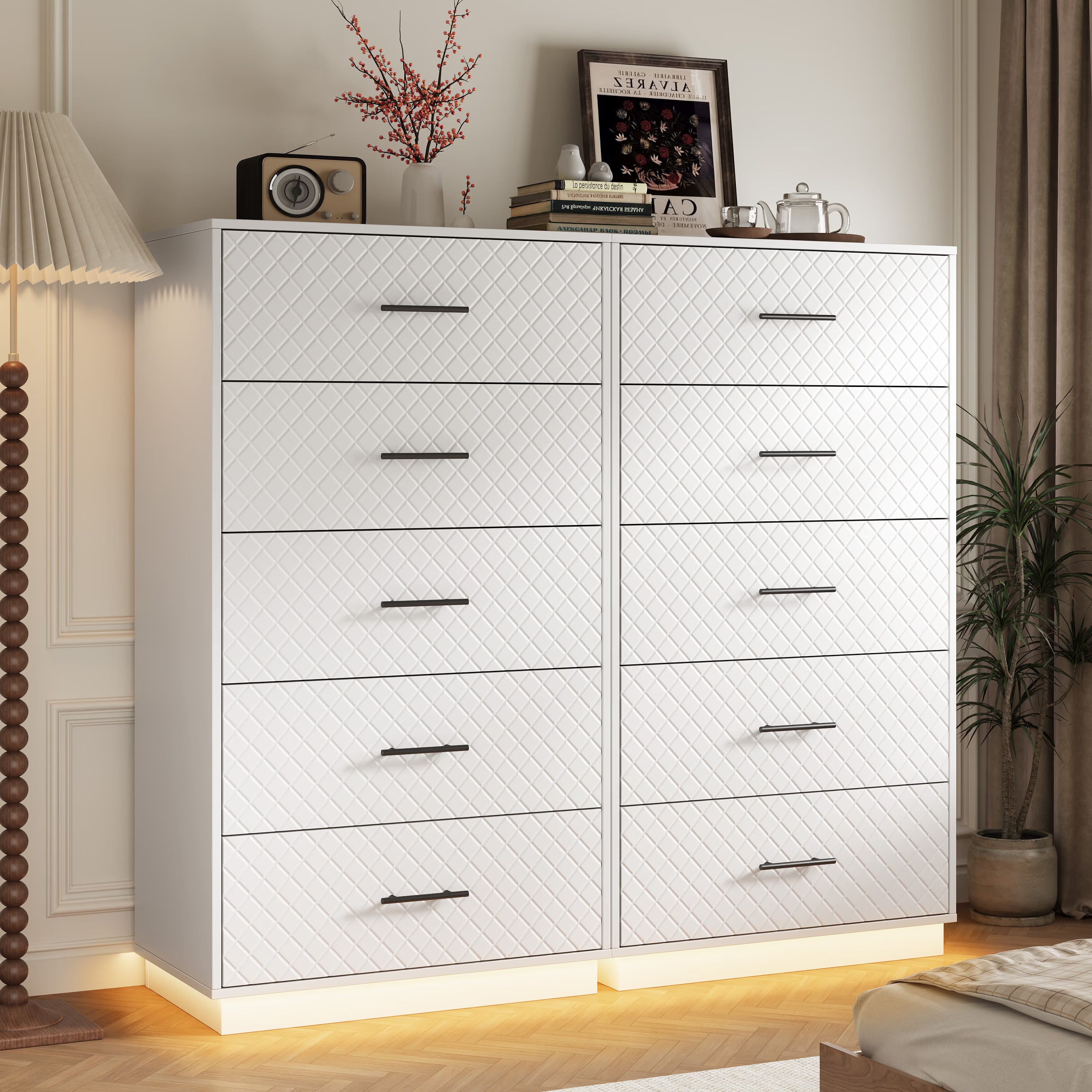 Set of two white tall 5-drawer dressers with warm LED base light in a bedroom