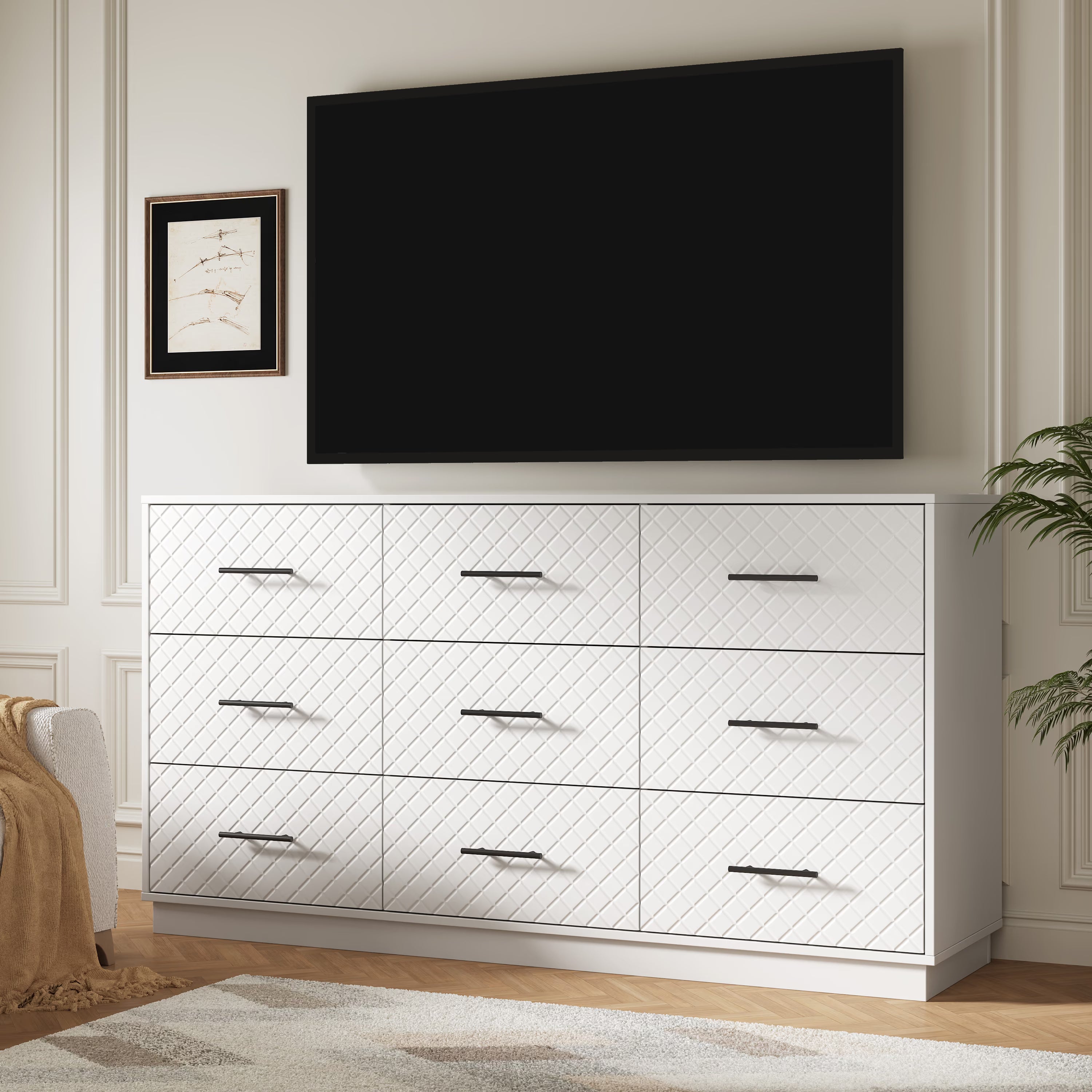 White 9-drawer double dresser used as a TV stand under a wall-mounted TV