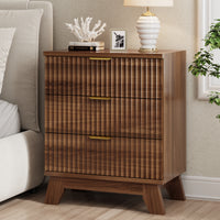 Modern walnut small dresser and end table used as a bedside nightstand, featuring wave-like fluted drawers and styled with coral decor.