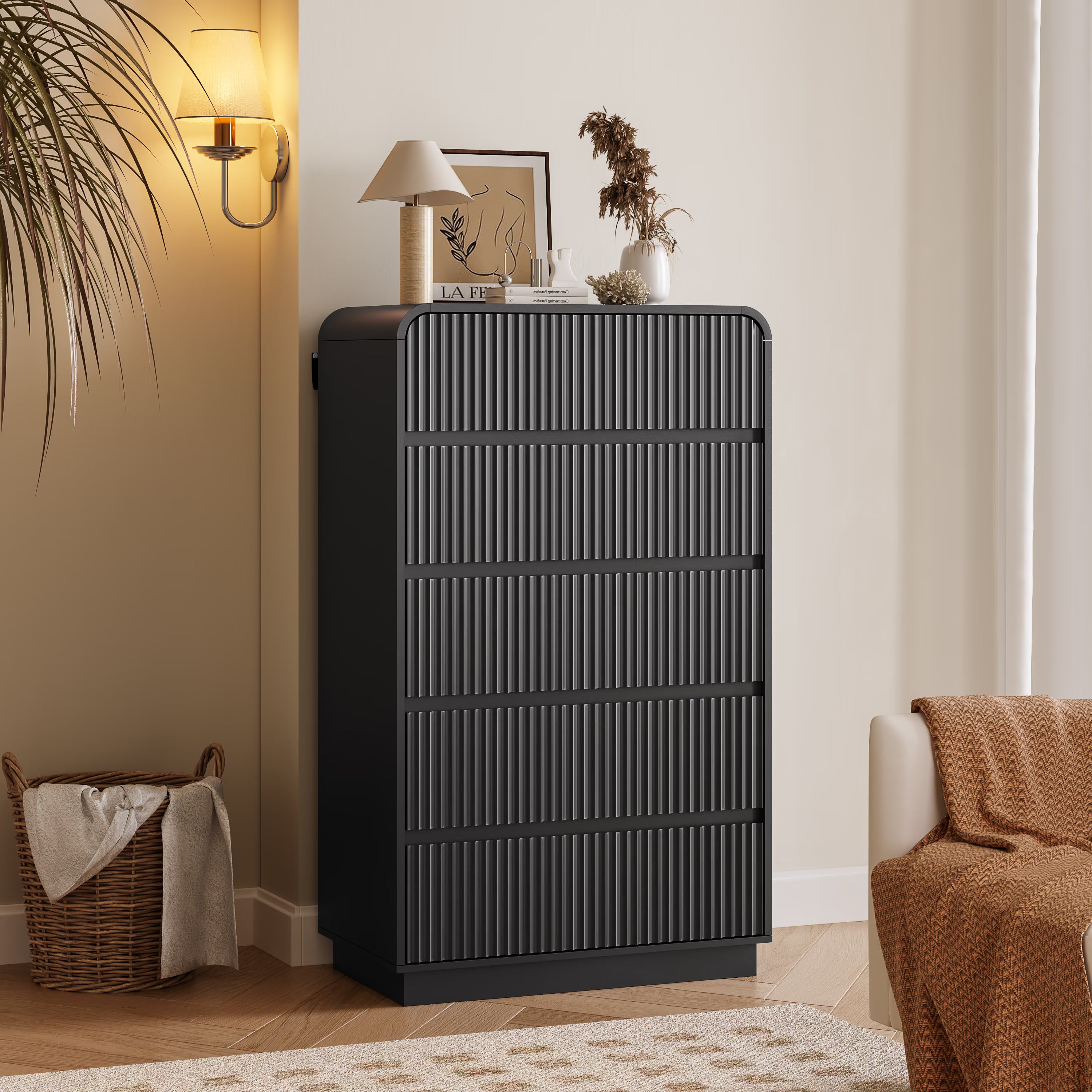 Linea modern black tall dresser for bedroom with 5 fluted drawers in a cozy living room setting.