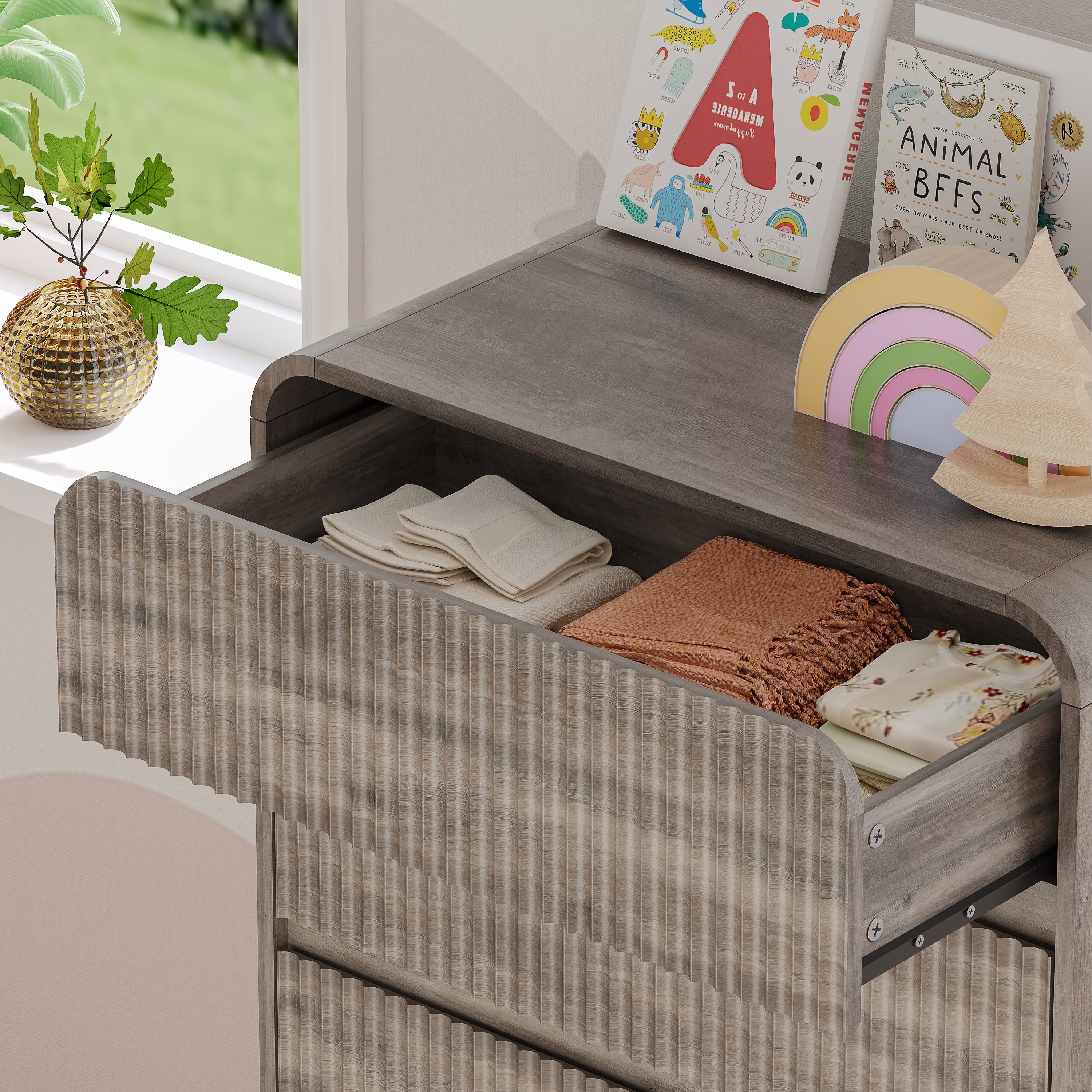Top surface of a stylish Linea gray kids dresser with smooth fluted drawer fronts and hidden handles.
