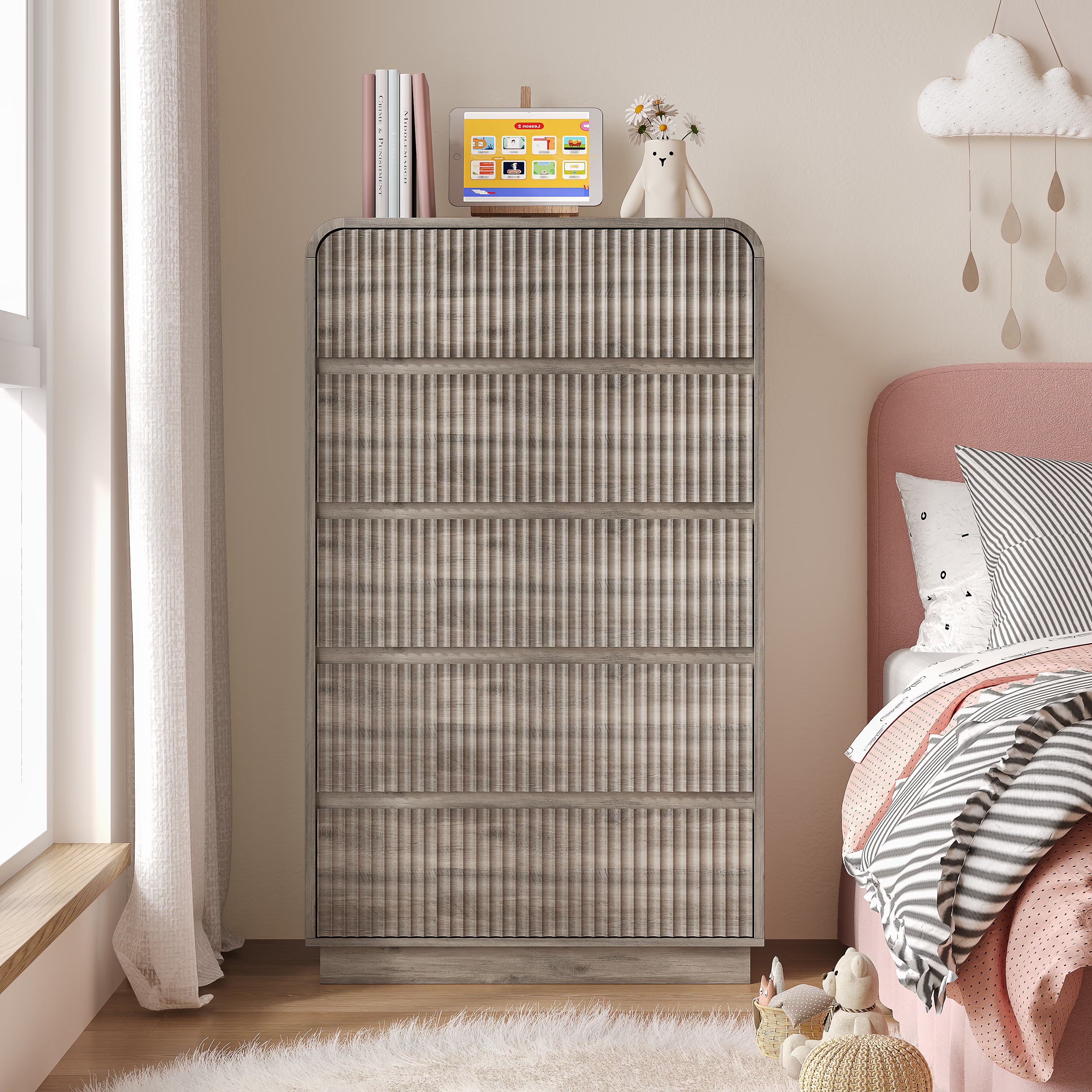 Minimalist Linea gray bedroom dresser with five storage drawers placed next to a modern bed.