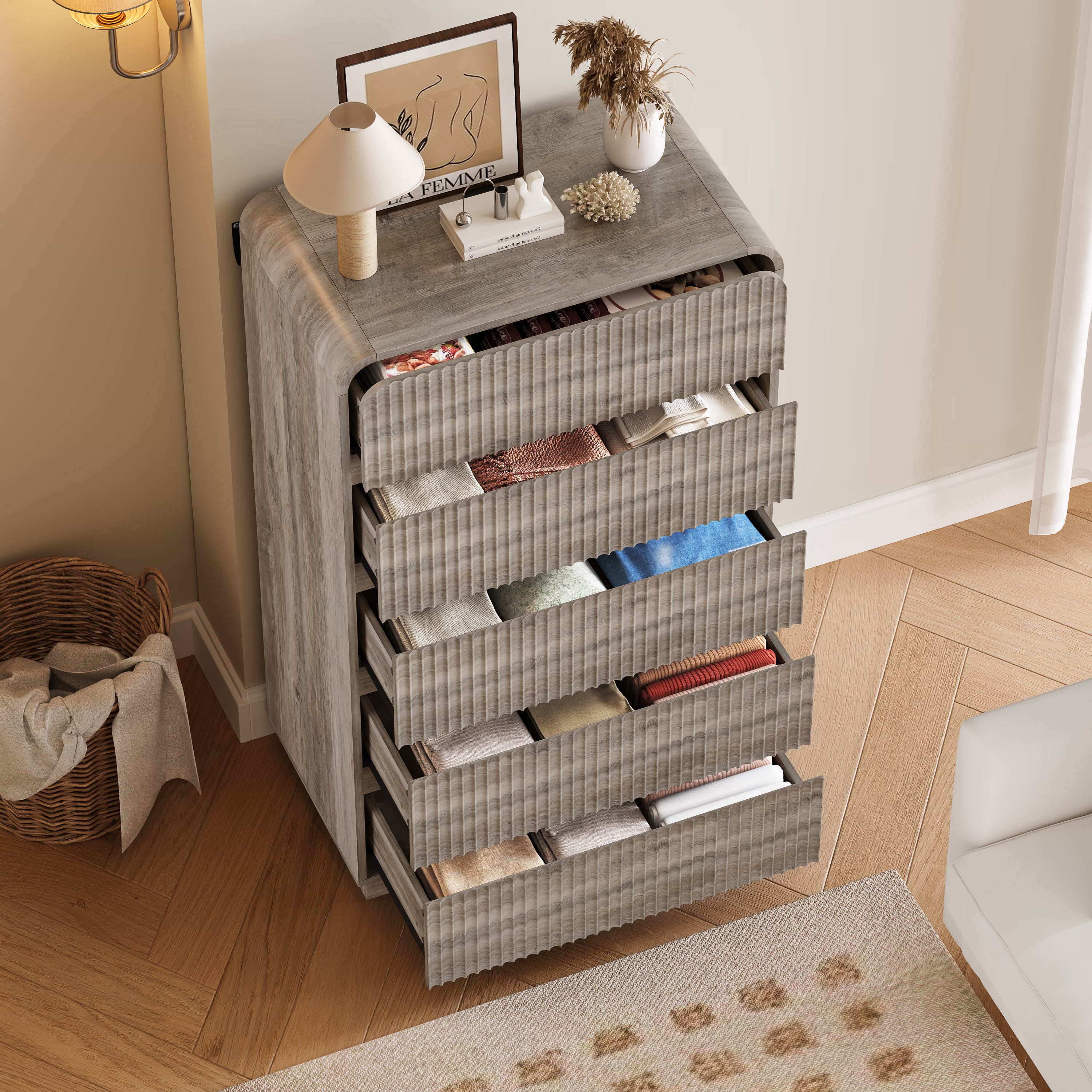 Open drawers of the Linea gray wood dresser displaying spacious storage capacity for folded clothes.