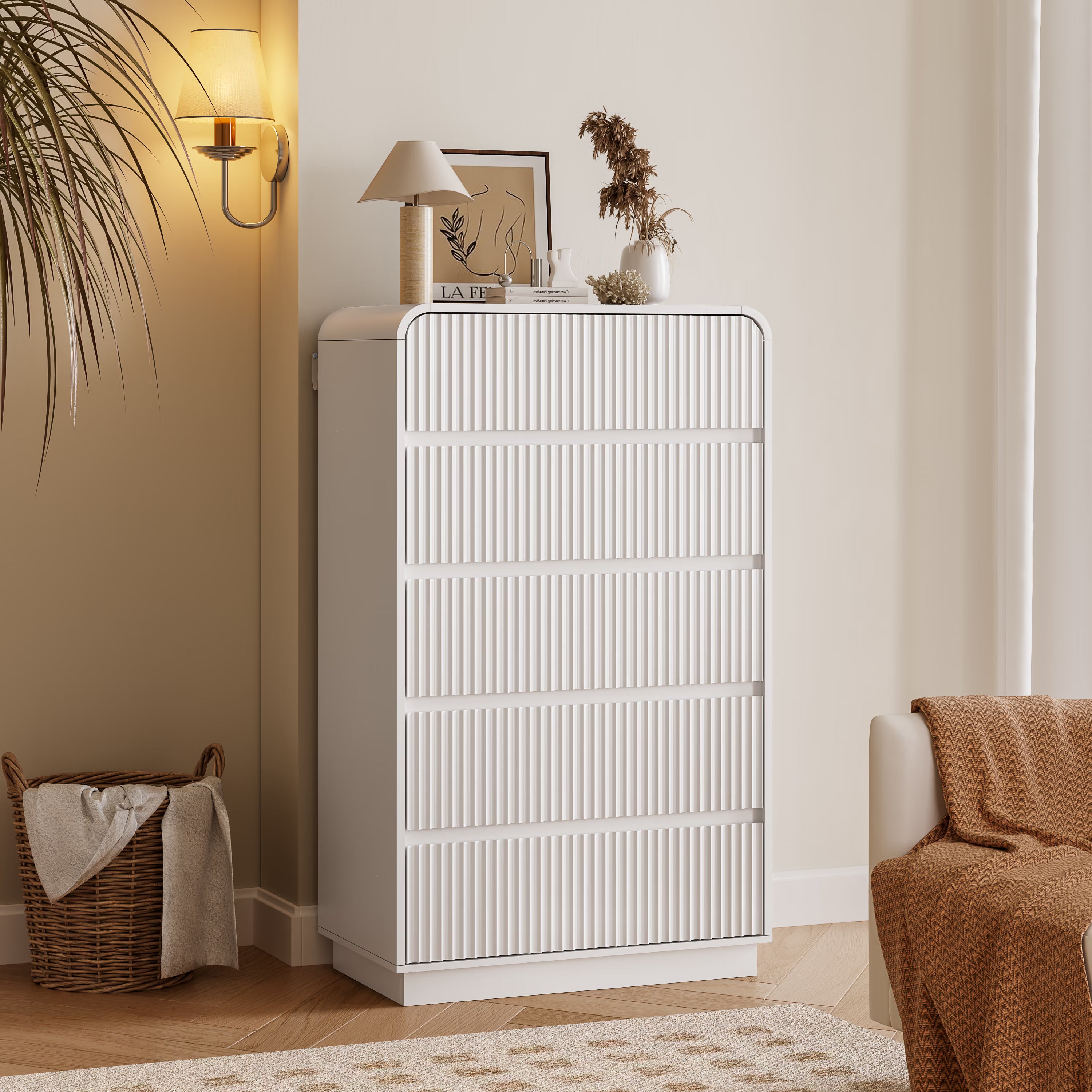 Linea modern white tall dresser for bedroom with 5 fluted drawers in a cozy living room setting.